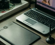 a laptop computer sitting on top of a wooden desk